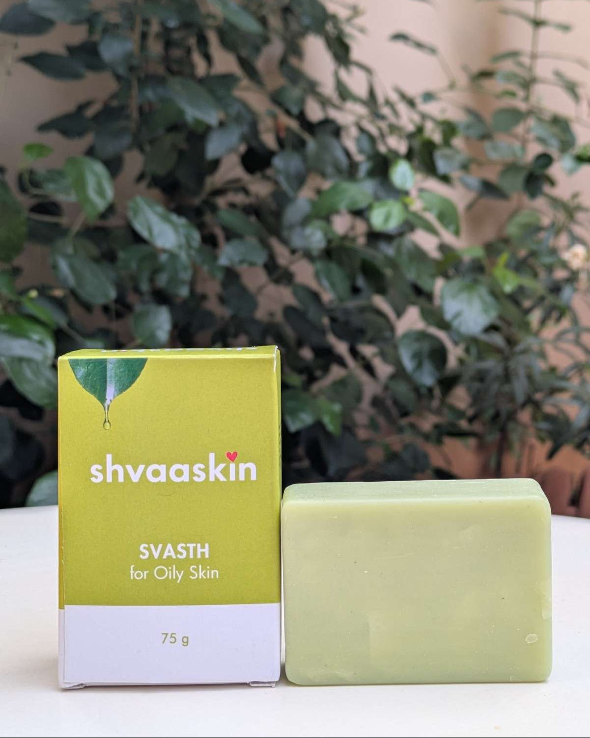 Shvaaskin soap bar and packaging on a white surface with greenery in the background